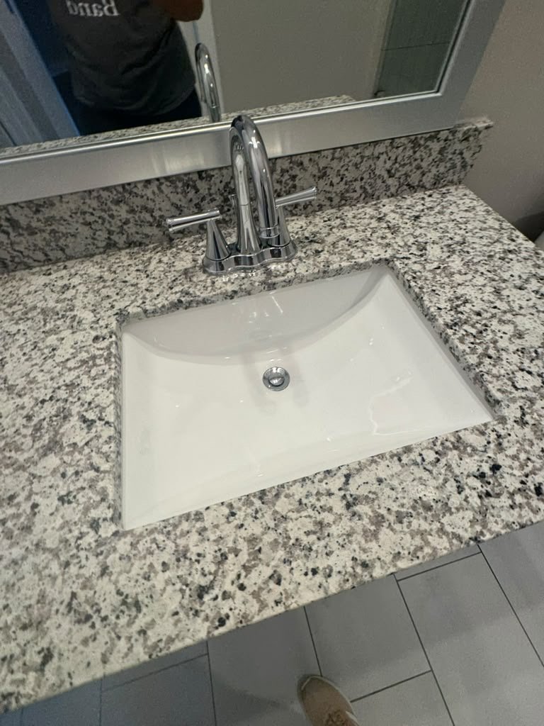 Granite vanity top with an undermount sink and chrome faucet
