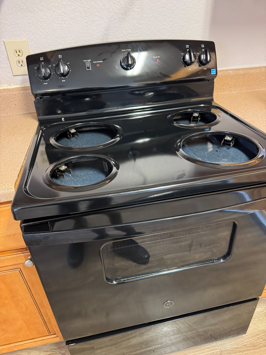 Cleaned stovetop and drip pans on an electric range