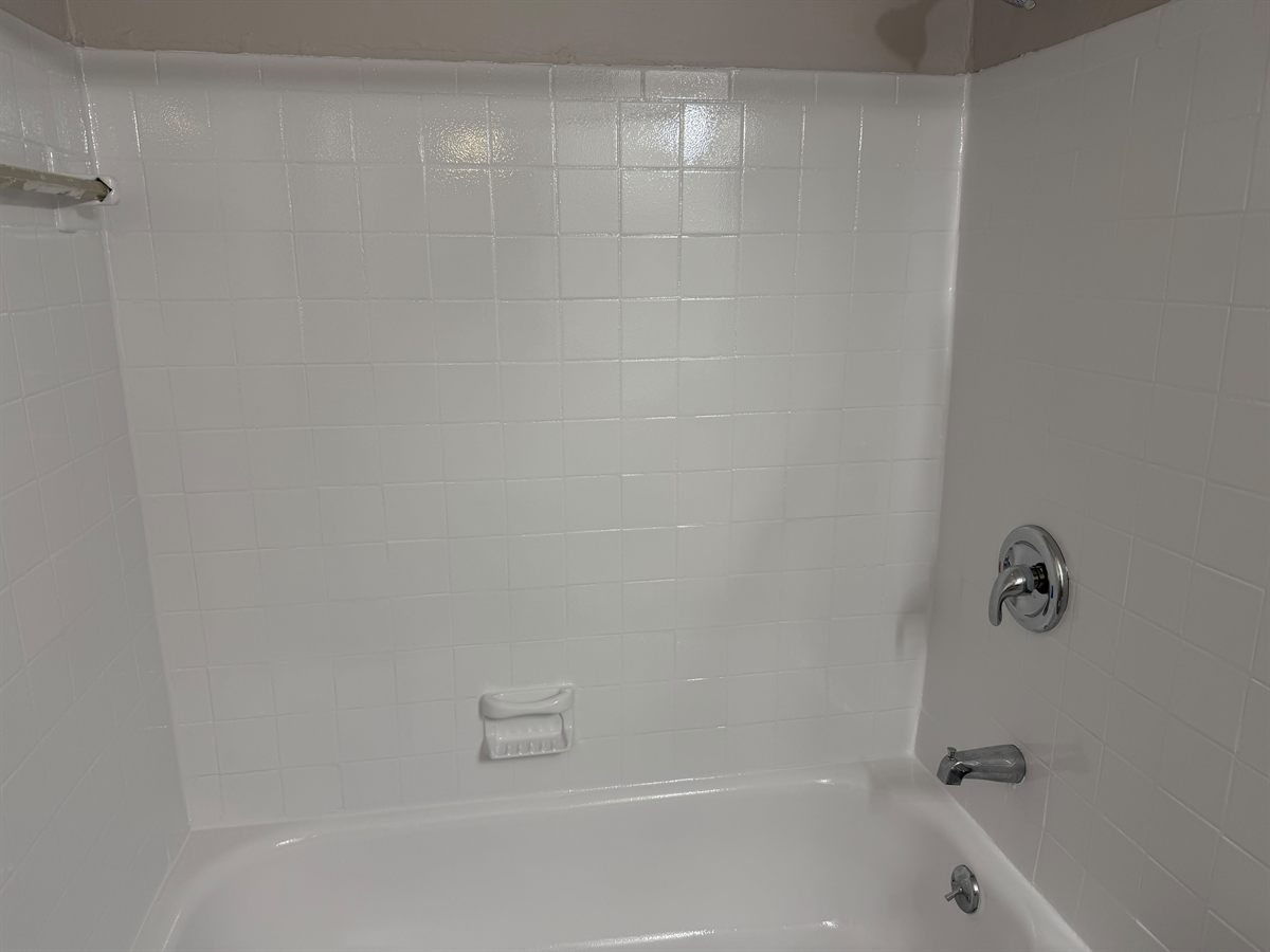 Refinished tile shower surround with new fixtures