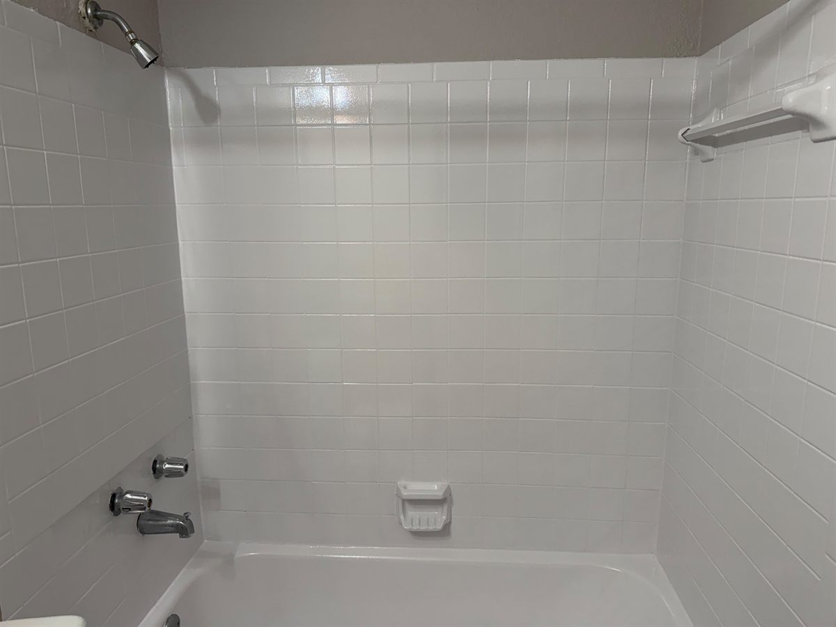 The same tile surround refinished to an even gloss white