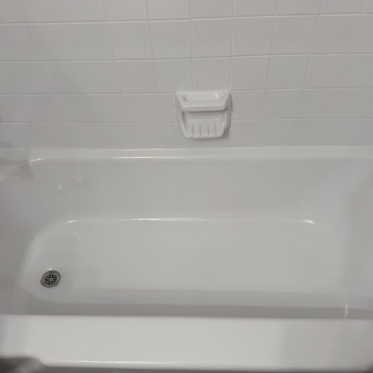 The same bathtub basin refinished to a clean gloss white